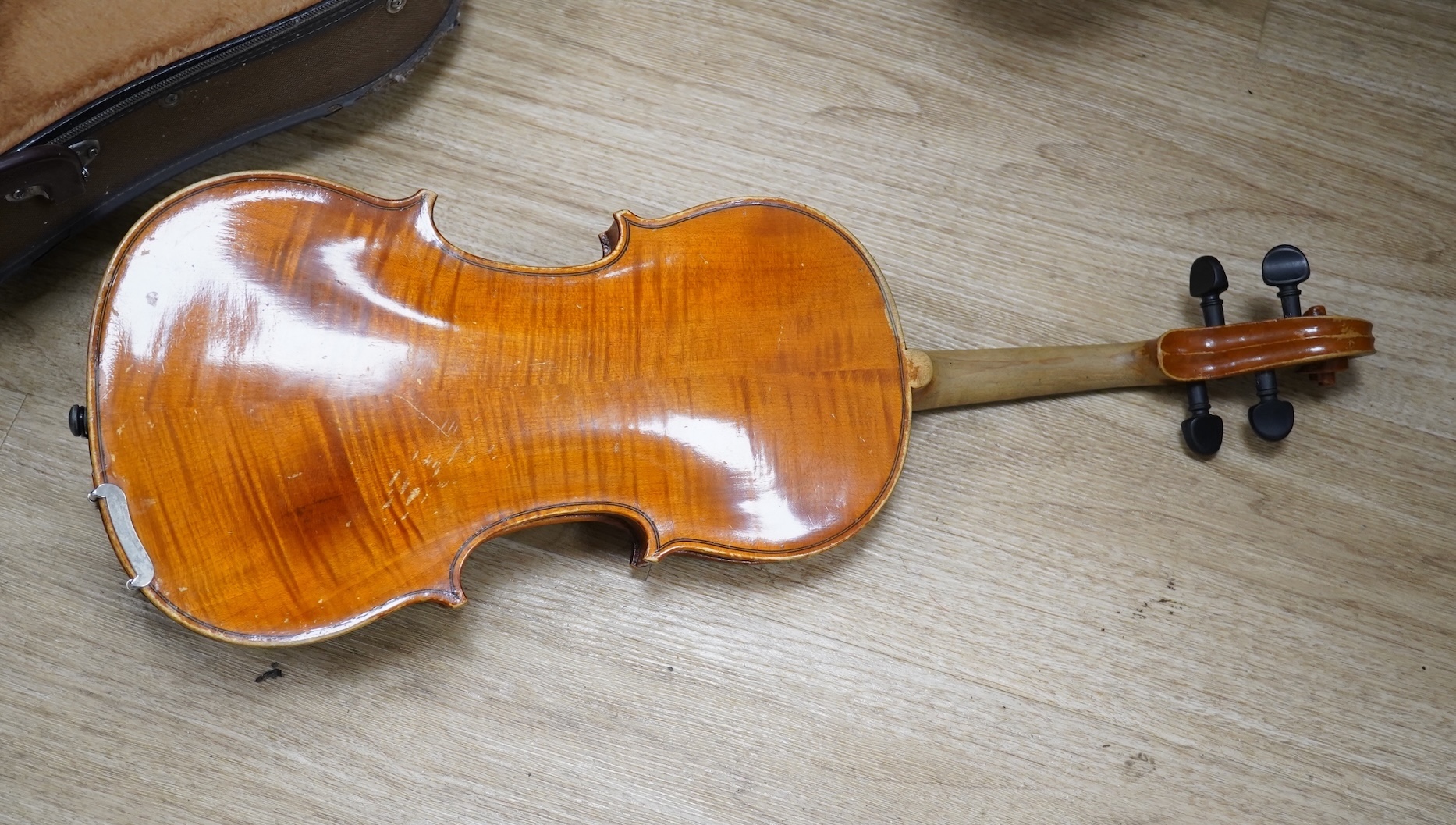 Two cased three quarter size violins, one labelled the London violin Co Ltd, length of back 33.5cm. Condition - both scratched